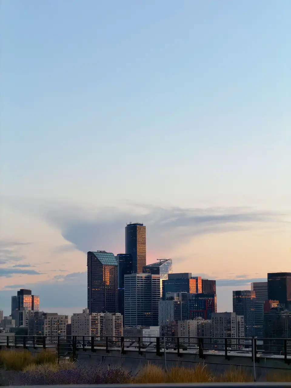 A city skyline glowing at dusk from a rooftop